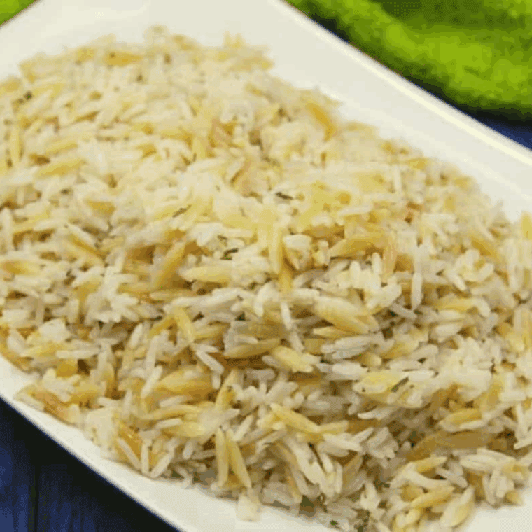 Bowl of copycat Applebee’s almond rice pilaf with parsley garnish