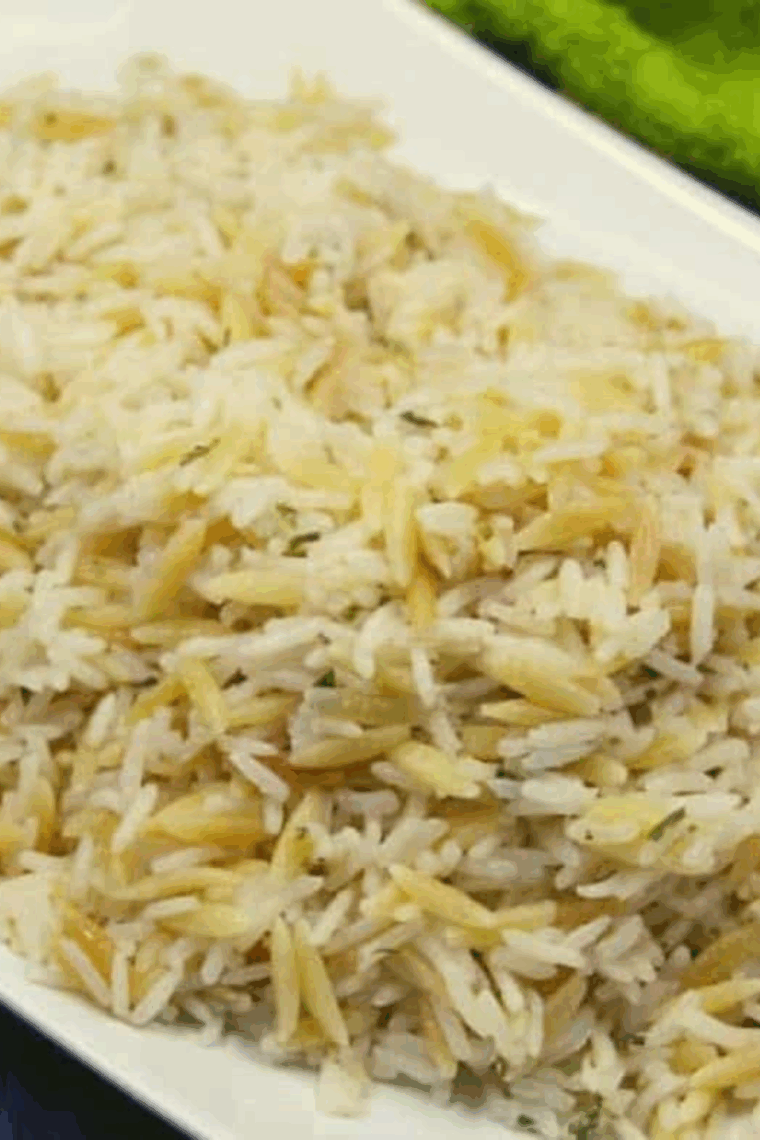 Close-up of Applebee’s Almond Rice Pilaf with toasted almonds and herbs served in a white bowl.