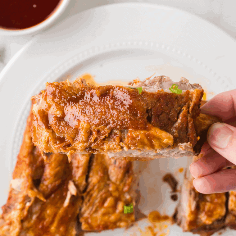 Thickened sauce coating the cooked short ribs, ready to serve.