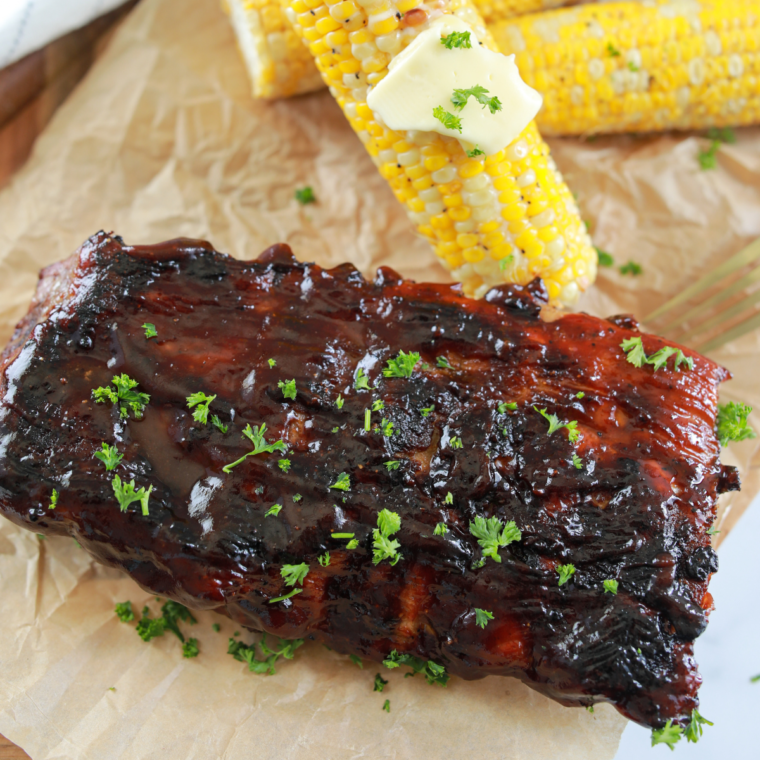 Grilled Blackstone ribs with a smoky flavor and crispy exterior, served on a platter.