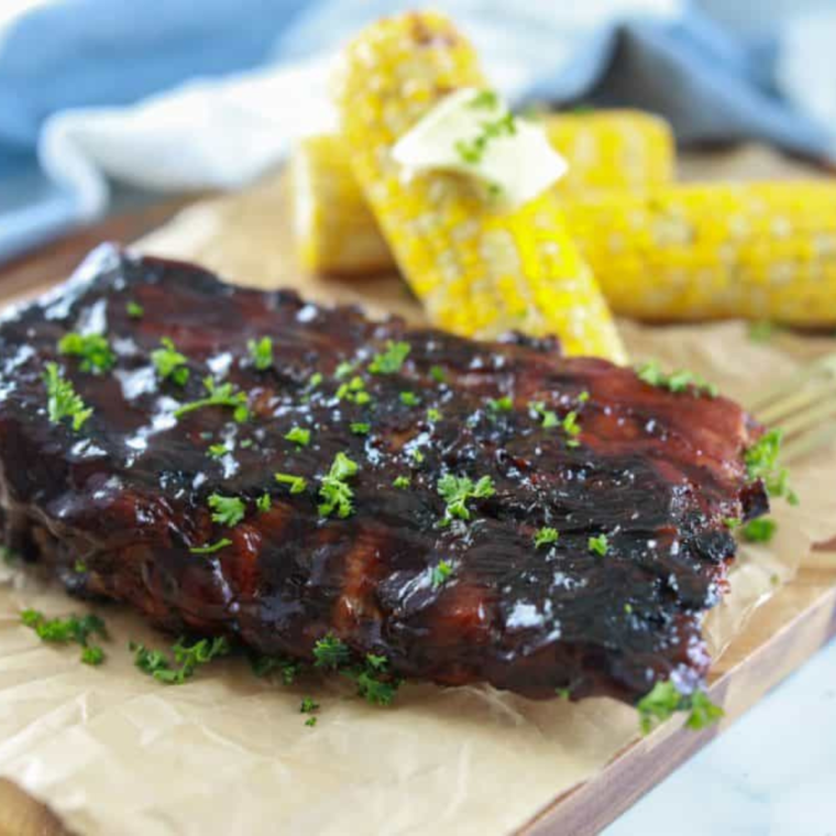 Deliciously cooked Blackstone ribs served with corn on the side.