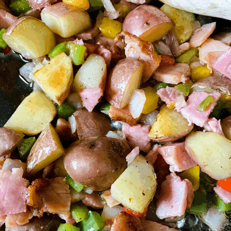Cooking the ingredients in a large skillet, until the vegetables are tender.
