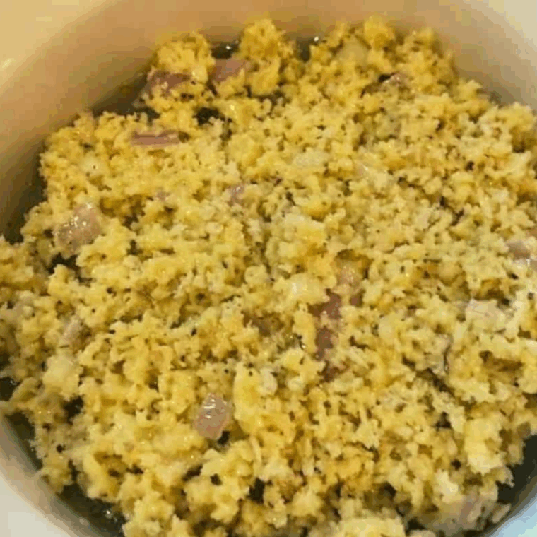 Panko breadcrumb topping mixed with butter, garlic, shallots, and herbs in a bowl.