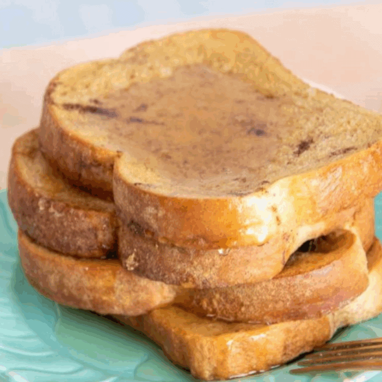 Golden Cracker Barrel-style French toast stacked on a plate with syrup and butter on top