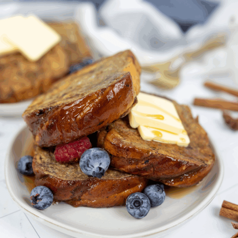 Plate of golden Cracker Barrel-style French toast topped with butter and syrup