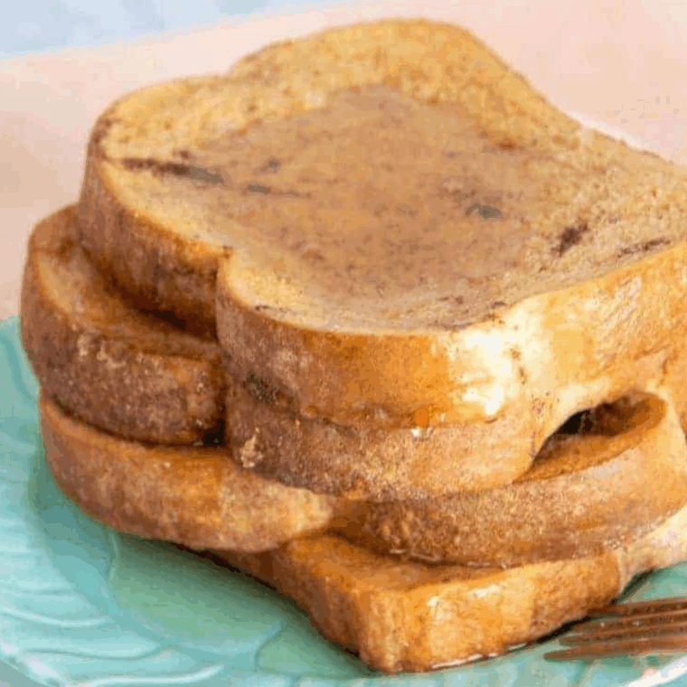 Stack of homemade Cracker Barrel-style French toast topped with butter and syrup