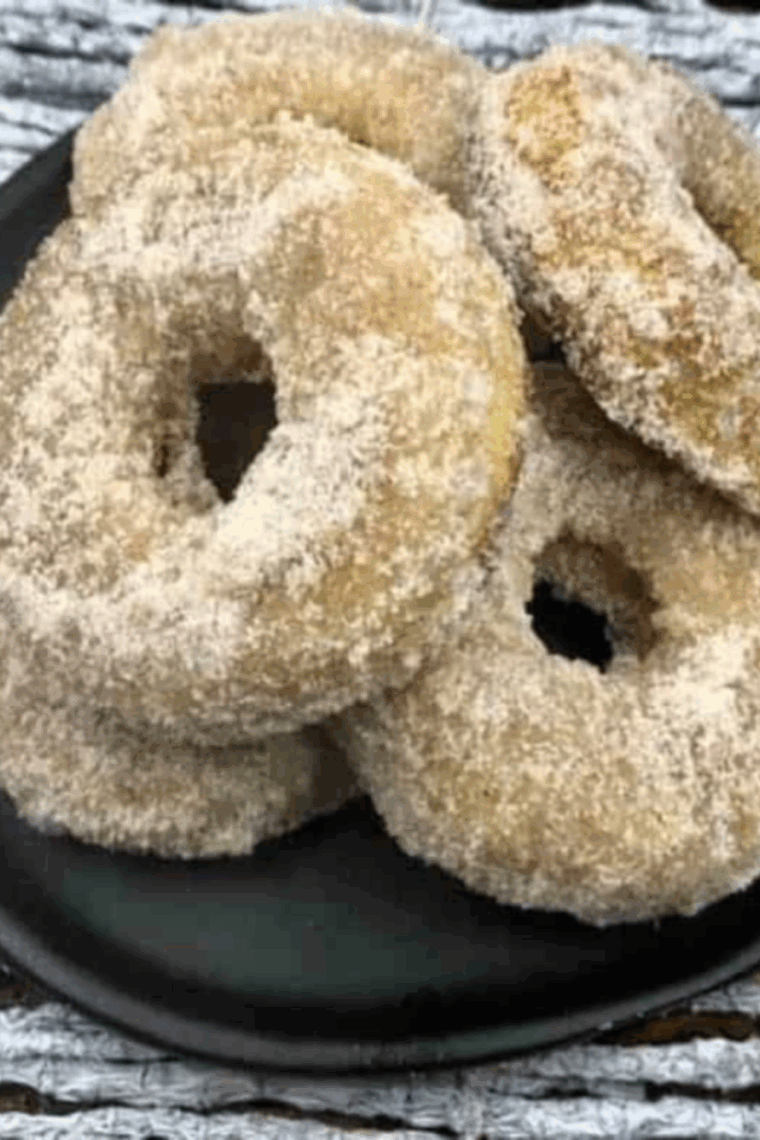 Golden, fluffy air fryer banana donuts on a plate, ready to enjoy.