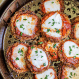Cheesecake Factory eggplant parmesan with crispy breaded slices, marinara sauce, and melted mozzarella cheese