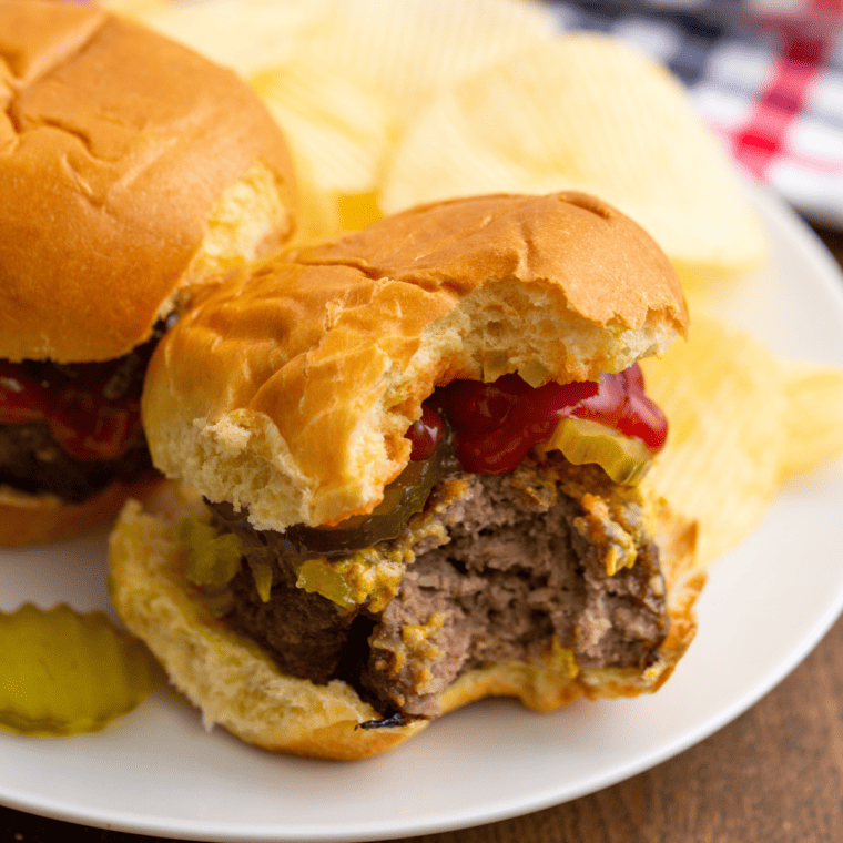 closeup: ground beef air fryer burger with a bite taken out of it