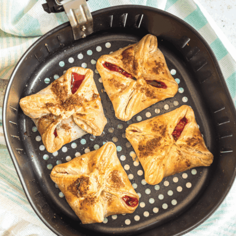 Cooked Homemade Arby's Cherry Turnovers in the air fryer basket.