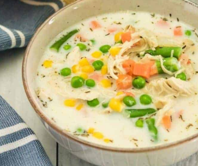 "Close-up of a finished bowl of Chicken Pot Pie Soup showing the hearty, savory ingredients and creamy broth."