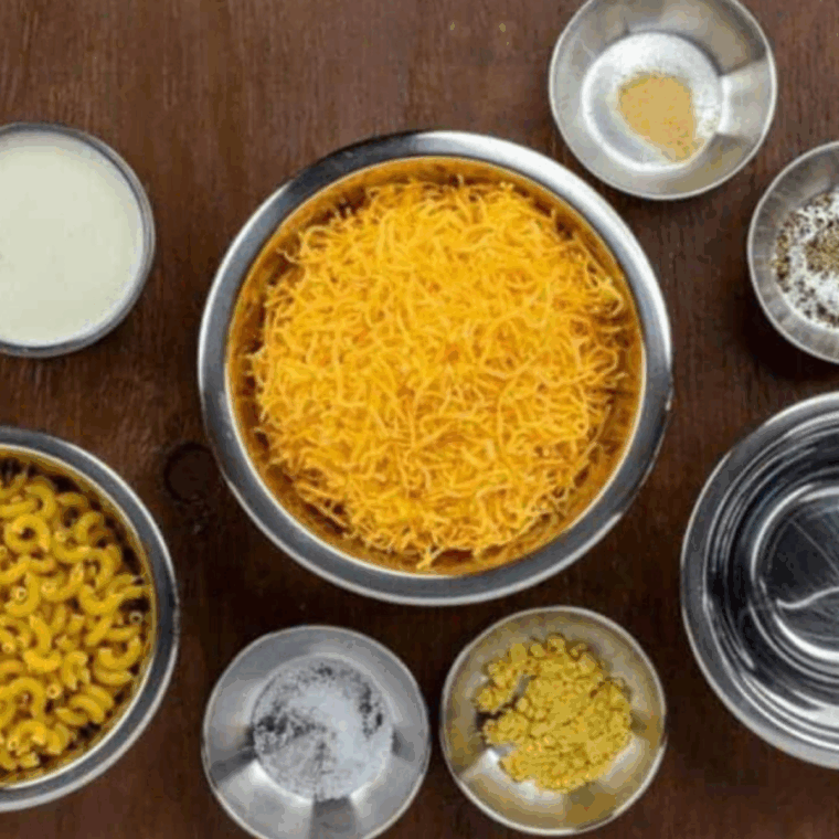 Ingredients needed for Outback Steakhouse Mac and Cheese on wooden kitchen table.