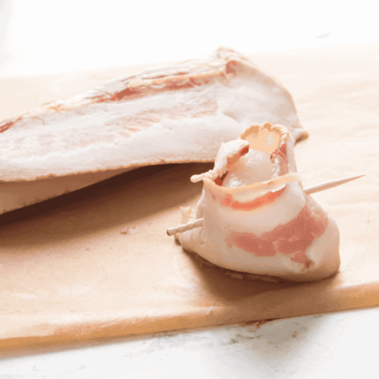 Wrapping the bacon around the scallop.
