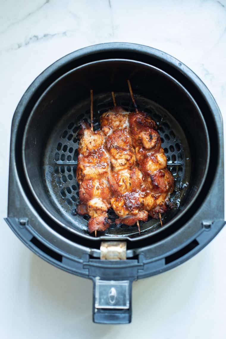 Pro Tips
Here are some pro tips to ensure your Air Fryer Barbecue Bacon Wrapped Chicken Bites turn out perfectly every time:

Choose the Right Bacon: Opt for thin to medium-thick bacon. Thick-cut bacon can take longer to crisp up and might not cook evenly with the chicken.

Uniform Chicken Pieces: Cut the chicken into even-sized bite-sized pieces. This ensures that they all cook at the same rate and are done simultaneously.

Prevent Stickiness: Lightly spray your air fryer basket with cooking spray or parchment paper with holes. This will help prevent the chicken bites from sticking to the basket.

Secure the Bacon: Use toothpicks to secure the bacon around the chicken pieces. This prevents the bacon from unraveling during cooking.

Avoid Overcrowding: Cook in batches if necessary. Overcrowding the air fryer can lead to uneven cooking and less crispy results.

Brushing the Sauce: Apply the barbecue sauce before cooking for a deeper flavor infusion. You can also brush a little extra sauce on the bites halfway through cooking for a more glazed effect.

Flipping is Key: Flip the chicken bites halfway through the cooking process. This ensures that the bacon gets crispy on all sides.

Check Internal Temperature: Ensure the chicken is fully cooked by ensuring its internal temperature reaches 165°F (74°C).

Rest Before Serving: Let the chicken bites rest for a few minutes after cooking. This helps redistribute the juices inside the chicken, making it more tender and flavorful.

Sauce Variations: Experiment with different types of BBQ sauce, or mix in some honey, mustard, or hot sauce to customize the flavor to your liking.

Garnish for Presentation: A sprinkle of fresh chopped parsley or chives can add color and a fresh flavor contrast.

Serving Suggestions: Serve with dips like ranch dressing, blue cheese, or more BBQ sauce on the side for added flavor.

Cleanup Tip: If you find the sauce has left a sticky residue in your air fryer, soaking the basket in warm, soapy water for a while will make cleaning easier.

Following these tips will help you create a delicious and visually appealing dish that's sure to be a hit with family and friends!

​

Faq's
What type of chicken is best to use for this recipe?

Boneless, skinless chicken breasts are typically used for their lean nature and even cooking. You can also use chicken thighs for a juicier option.
Can I use thick-cut bacon for this recipe?

It’s best to use thin to medium-thick bacon as it wraps easily and cooks evenly with the chicken. Thick-cut bacon may not cook through properly and can leave the chicken overcooked.
How do I prevent the chicken bites from sticking to the air fryer?

Lightly spray the air fryer basket with cooking oil or use a perforated parchment liner designed for air fryers to prevent sticking.
How long should I cook the chicken bites in the air fryer?

Typically, it takes about 10-15 minutes at 390°F (200°C), depending on your air fryer model. It's important to flip them halfway through for even cooking.
How do I know when the chicken is done?

The internal temperature of chicken should have an internal temperature of 165°F (74°C). A meat thermometer is handy for checking this. The size of the chicken will determine the cooking time.
Can I prepare these chicken bites ahead of time?

Yes, you can wrap the chicken in bacon and refrigerate them for a few hours before cooking. Just brush them with BBQ sauce right before air frying.
What are some good dipping sauces for these chicken bites?

Ranch dressing, blue cheese sauce, honey mustard, or extra barbecue sauce are great options.
Can I make this recipe gluten-free?

Yes, just ensure that the barbecue sauce and any other added ingredients are gluten-free.
How should I store leftovers?

Store any leftovers in an airtight container in the refrigerator for up to 3 days. Reheat in the air fryer for best results.
Can I freeze the cooked chicken bites?Yes, once cooled, you can freeze them in a sealed container or freezer bag. Reheat in the air fryer straight from frozen, adjusting the cooking time as needed.

Are these chicken bites keto-friendly?

They can be, depending on the barbecue sauce used. Opt for a low-sugar, keto-friendly BBQ sauce to make this dish suitable for a ketogenic diet.
Can I make these bites in an oven if I don't have an air fryer?
Yes, you can bake them in an oven preheated to 400°F (205°C) for about 20-25 minutes, or until the bacon is crispy and the chicken is cooked through.
More Air Fryer Recipes
