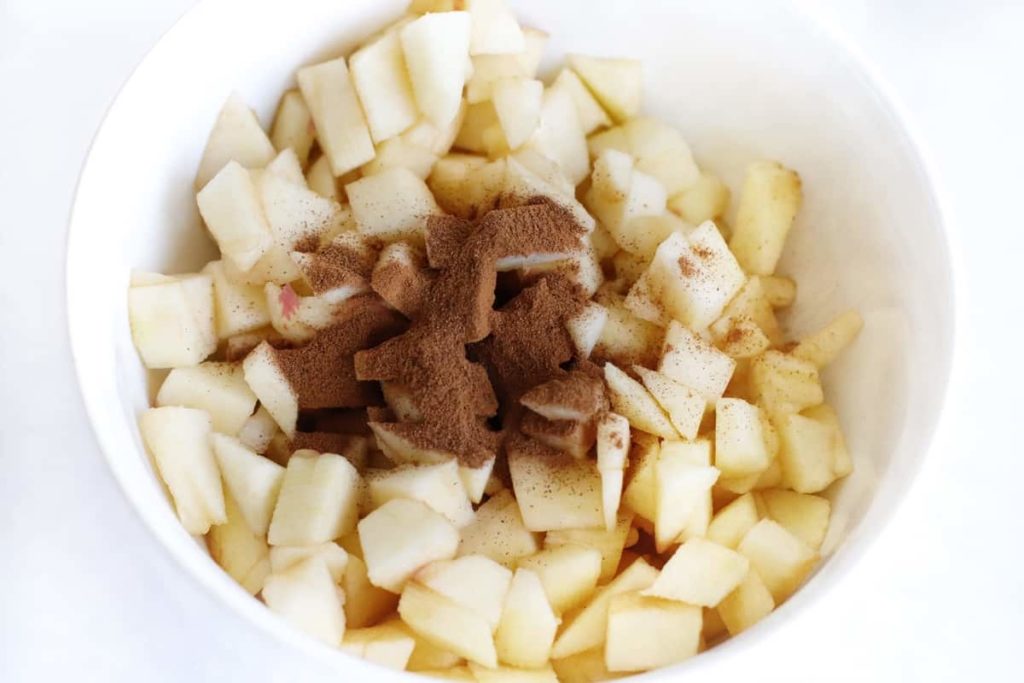 Chopped Apples in Bowl with Ground Cinnamon