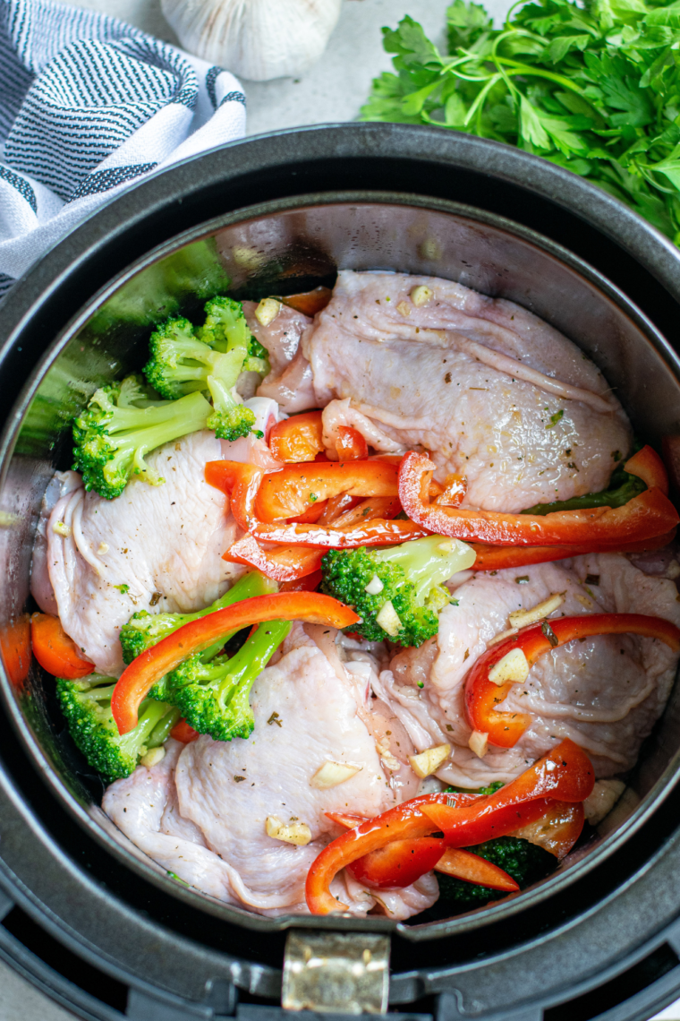 Air fryer preheating to 375°F for cooking honey balsamic chicken thighs.