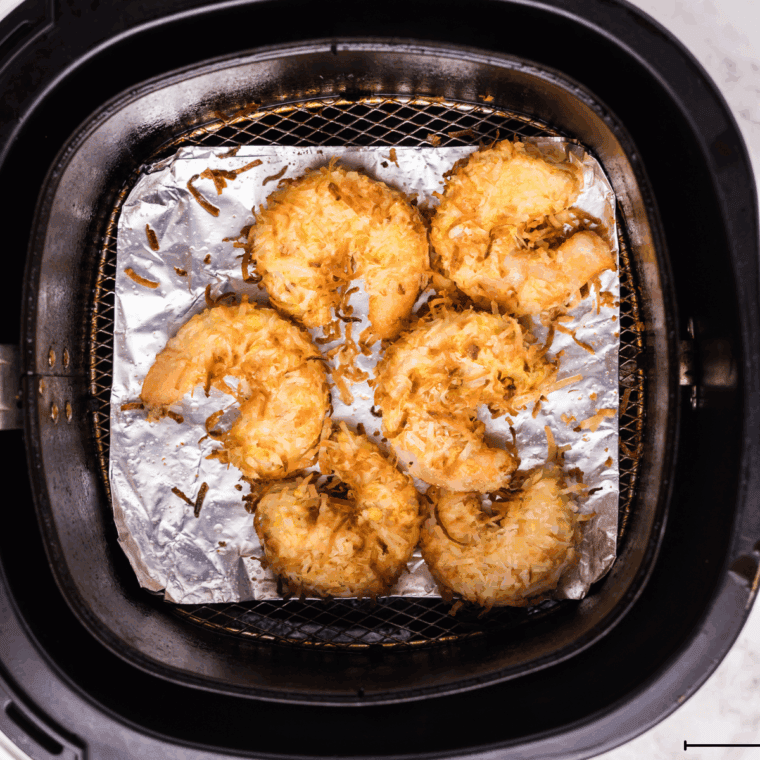 Cooked Captain D’s Coconut Shrimp in the air fryer basket.