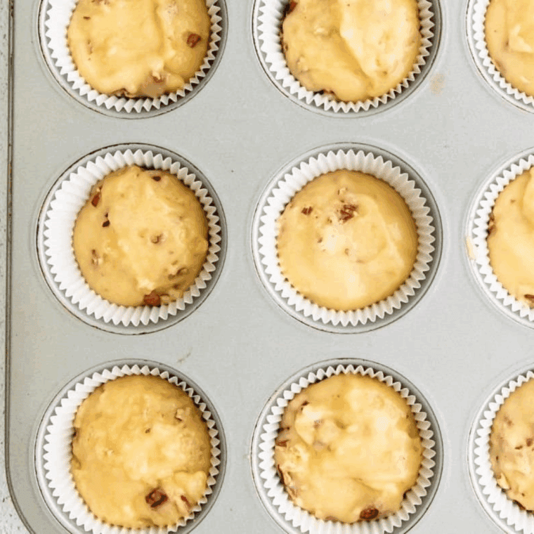 Cupcake batter evenly portioned into liners, ready for baking in the oven until golden and set