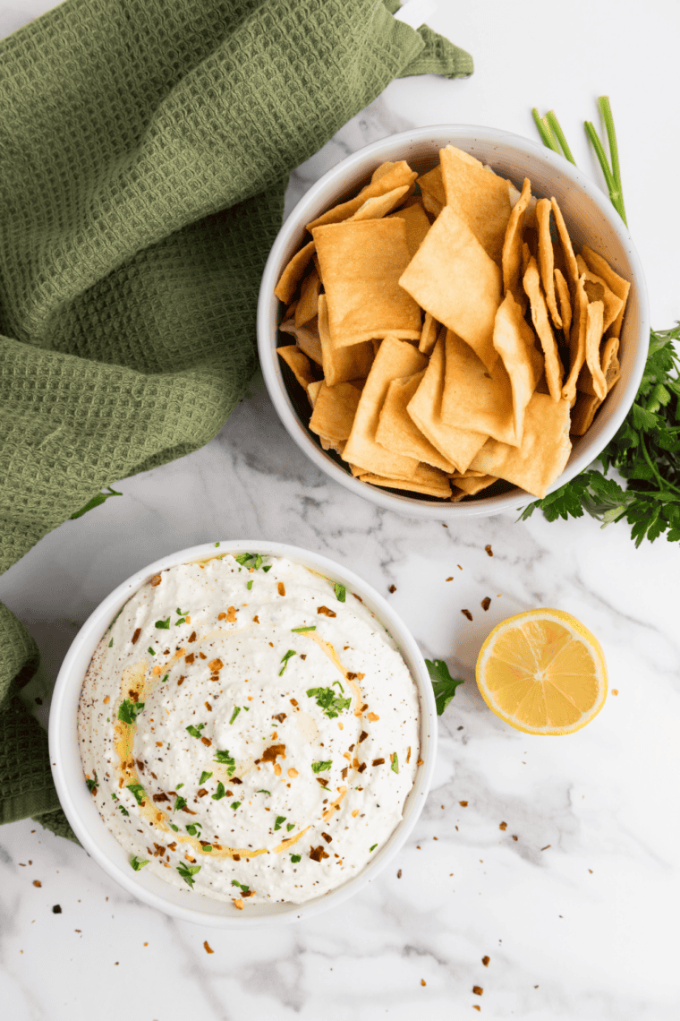 Creamy homemade Lawson's Chip Dip in a bowl with potato chips for dipping.