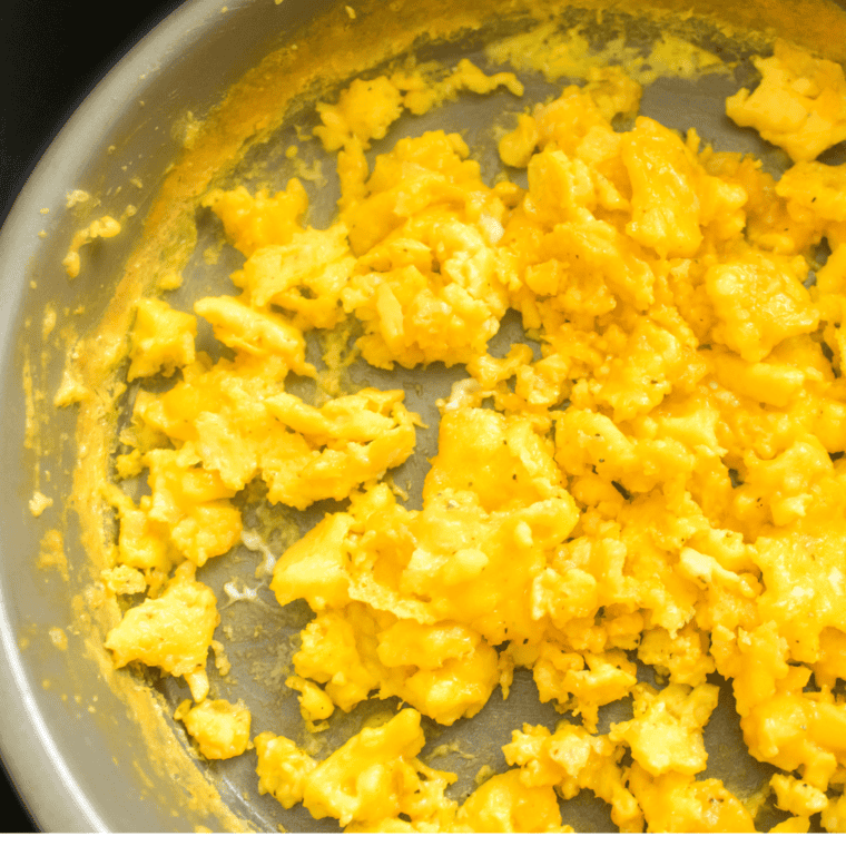 overhead closeup: round metal pan filled with scrambled eggs made in air fryer