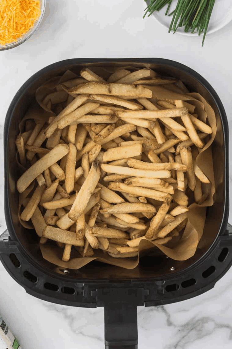 Place frozen French fries into the air fryer basket.