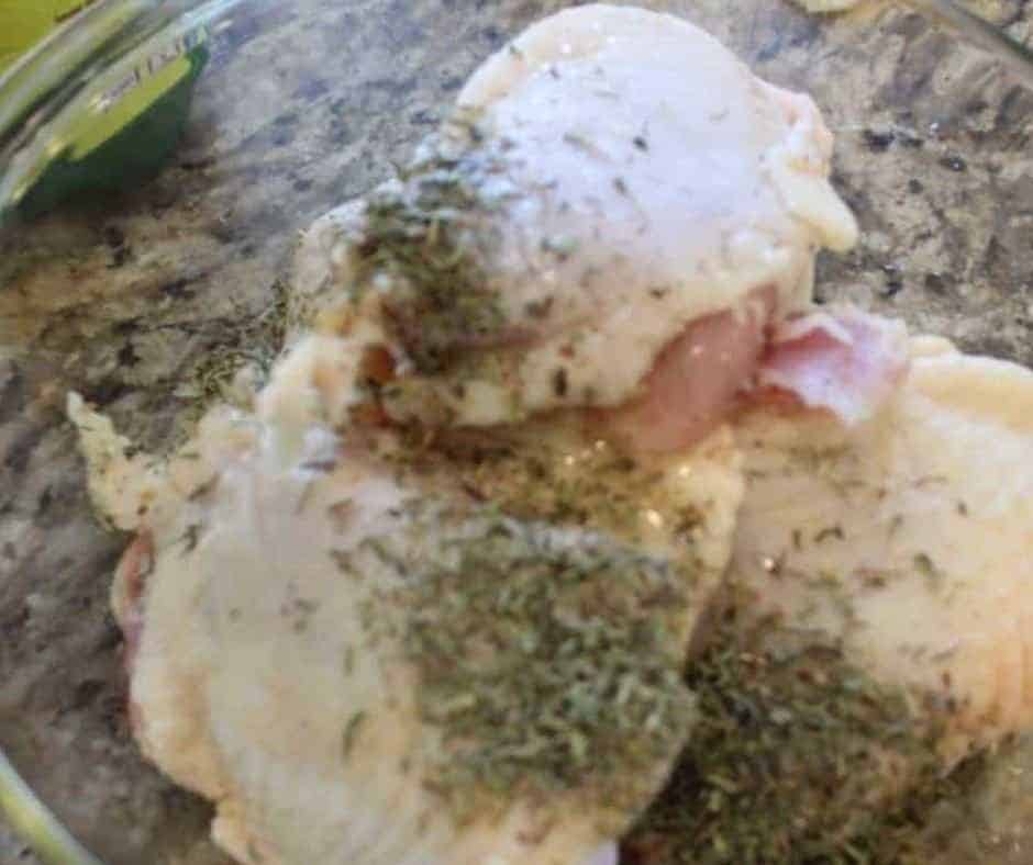 Add spcies and lemon to the chicken thighs