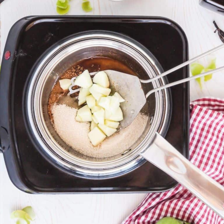 Mixing cornstarch and water in a small bowl, then simmering apples with cinnamon, vanilla, and sugar in a saucepan.