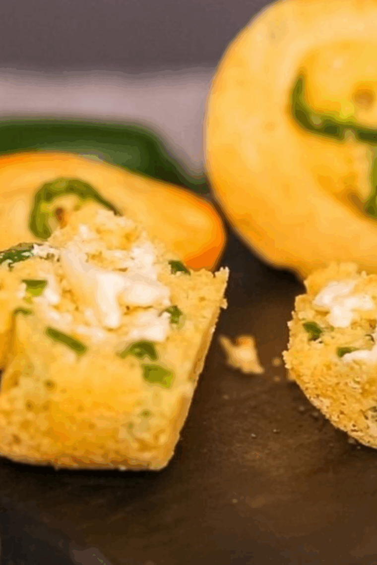 Golden air fryer jalape&ntilde;o corn muffins with visible pieces of chopped peppers