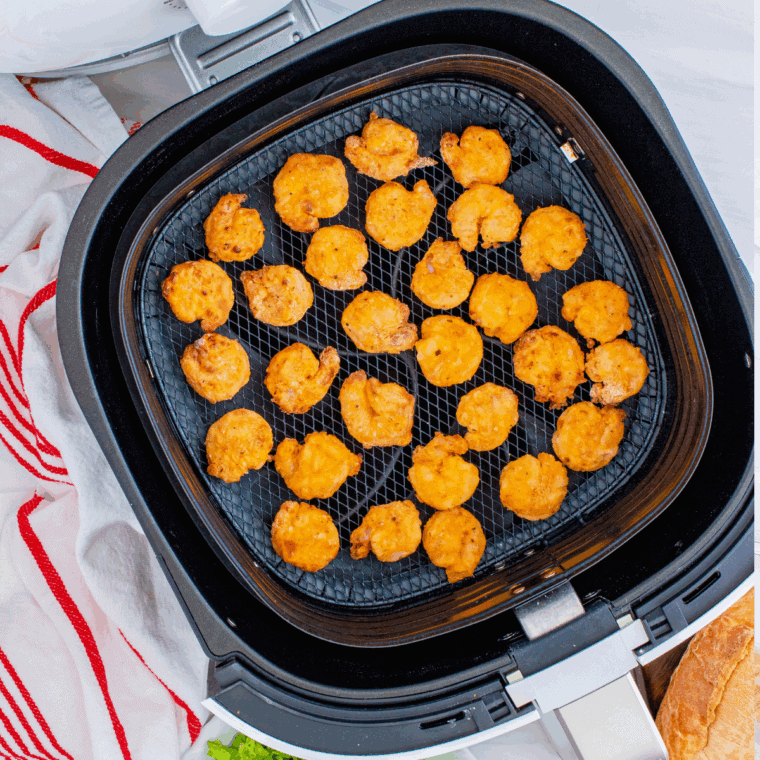Cooked shrimp in the air fryer basket.