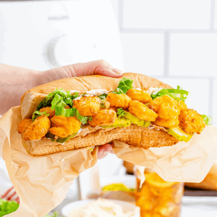 Arthur Treacher’s Po Boy Sandwich with crispy fish, lettuce, tomato, and tartar sauce on a hoagie roll.