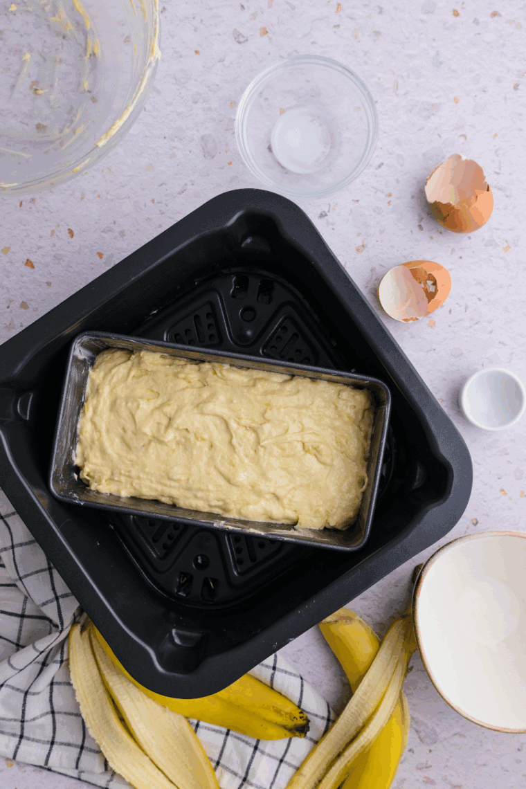 Banana cake batter poured into greased pan, placed in air fryer, set to 320&deg;F for 25&ndash;30 minutes.