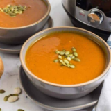 Bowl of pumpkin soup, with the Instant Pot in the background.