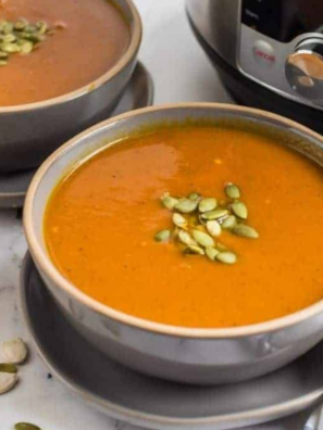 Bowl of pumpkin soup, with the Instant Pot in the background.