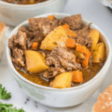 Copycat Panera Bread beef stew with tender beef, carrots, and potatoes in a rich broth, served in a bowl with crusty bread