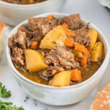 Copycat Panera Bread beef stew with tender beef, carrots, and potatoes in a rich broth, served in a bowl with crusty bread