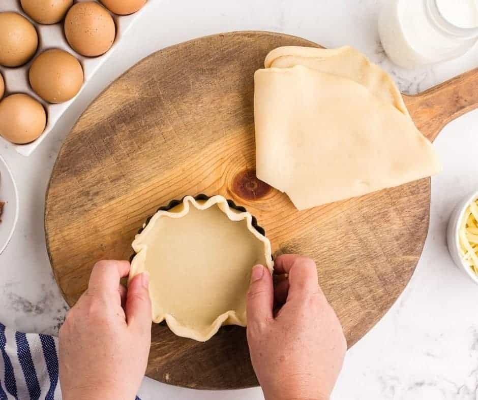 pressing pie dough into tart pan