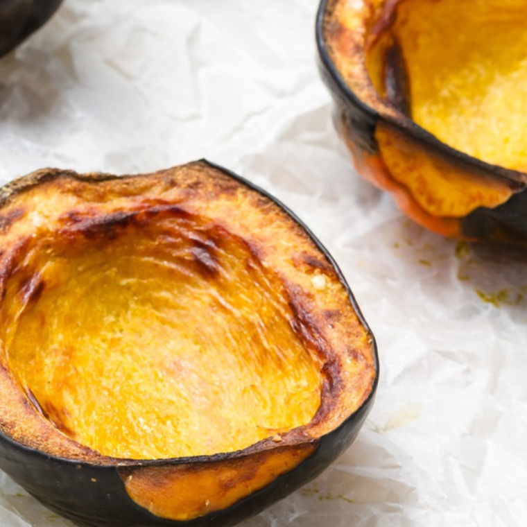 Perfectly roasted Air Fryer Acorn Squash slices, golden brown and garnished with herbs.