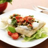 Golden, crispy chicken chimichangas cooked in the air fryer, served on a plate with dipping sauce.