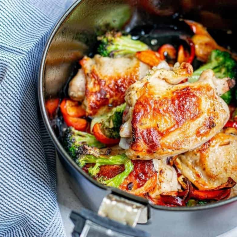 A plated serving of Air Fryer Chicken Thighs and Vegetables, garnished and ready to enjoy.