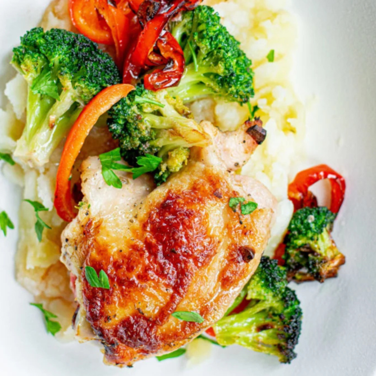 Juicy air-fried chicken thighs with vibrant bell peppers and broccoli