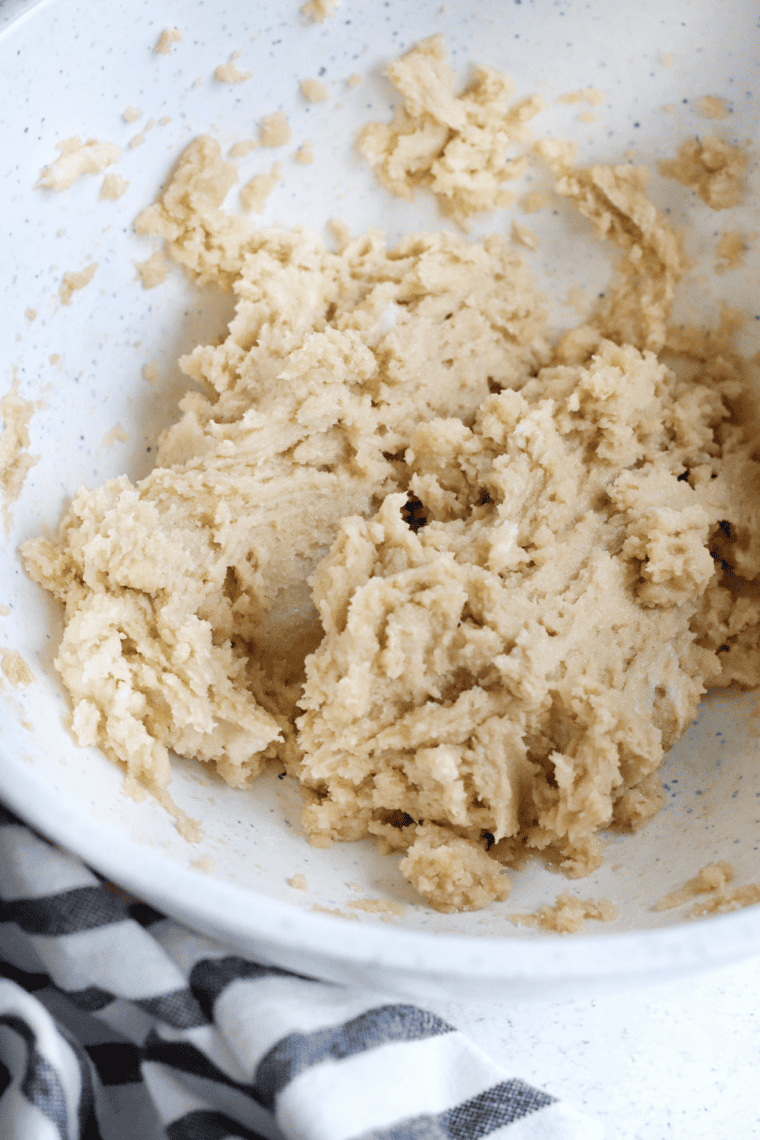 Creaming butter with granulated and brown sugar until light and fluffy.