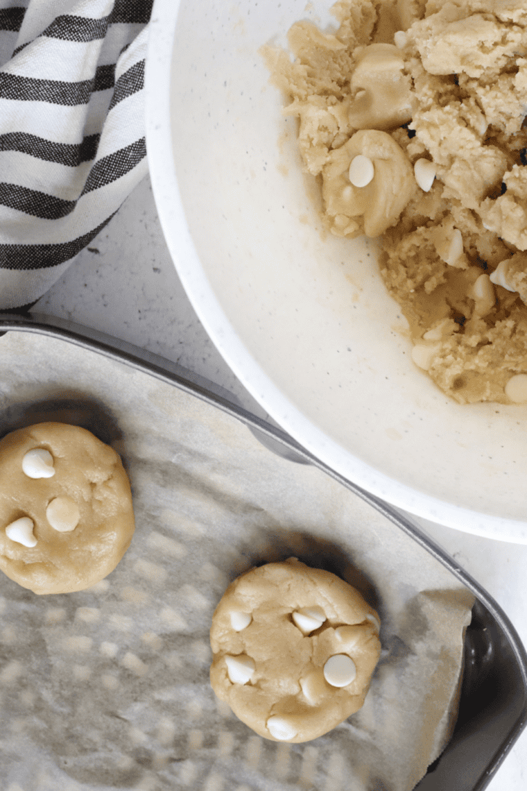 White chocolate chip cookies baking in air fryer until lightly golden.