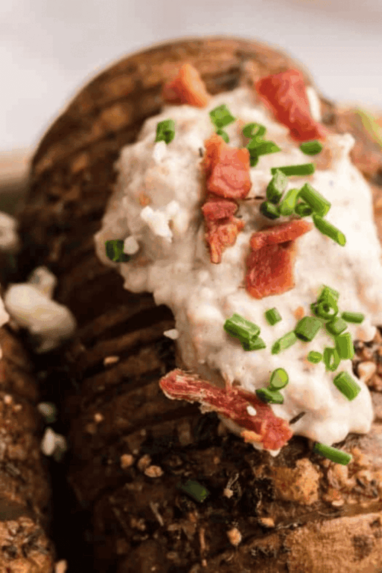 Golden Hasselback potatoes cooked in an air fryer, topped with crispy bacon and melted bleu cheese