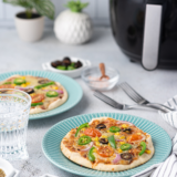 The easiest 5-minute weeknight pizza &mdash; a crispy pita bread crust, melty mozzarella, and any toppings you love, all cooked in your air fryer. No dough, no preheating an oven, no fuss.