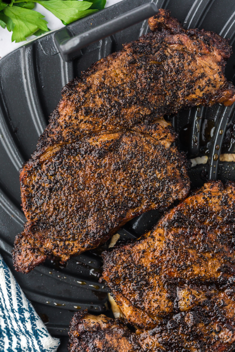 Close-up of air fryer ribeye steak sliced juicy and medium-rare on cutting board