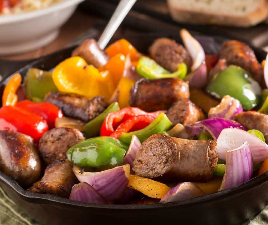 sausage, bell peppers, and onions in a cast iron skillet