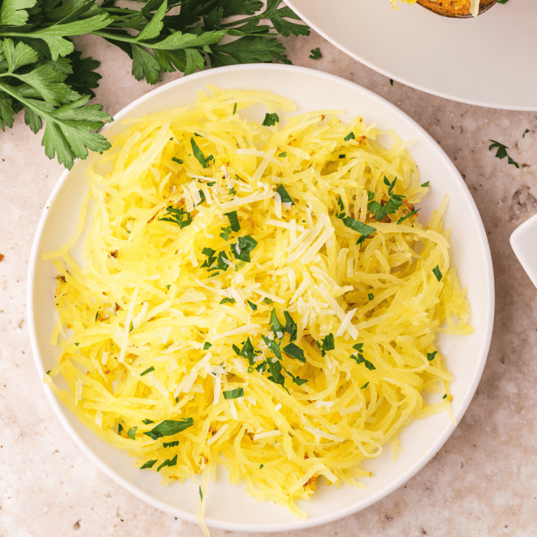 Shredded air fryer spaghetti squash strands in a white bowl