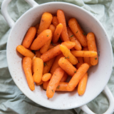 Bowl of Bob Evans copycat glazed carrots garnished with fresh herbs