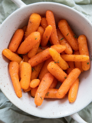 Bowl of Bob Evans copycat glazed carrots garnished with fresh herbs