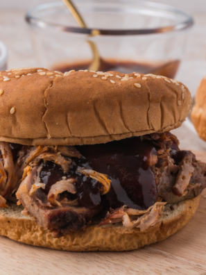 Copycat Mission BBQ pulled pork piled high on a toasted brioche bun with coleslaw and barbecue sauce